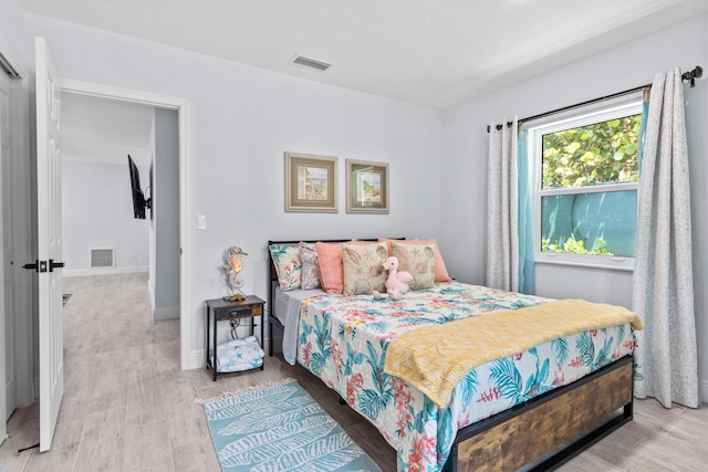 bedroom with light hardwood / wood-style floors