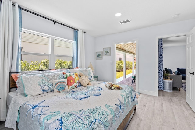 bedroom with light wood-type flooring and access to exterior