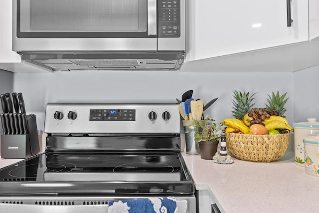 kitchen featuring appliances with stainless steel finishes and white cabinets