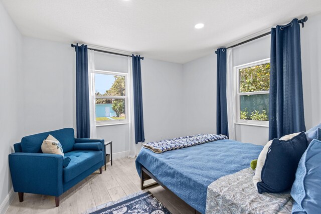 bedroom with hardwood / wood-style floors