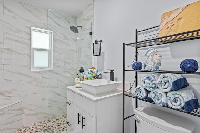 bathroom with a shower with shower door, toilet, and vanity