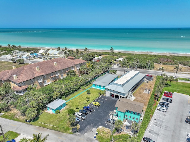 bird's eye view with a water view and a beach view