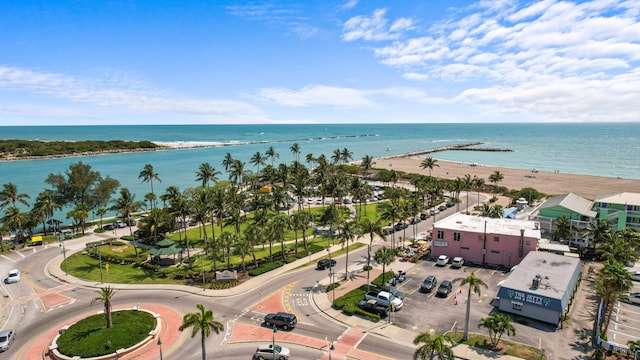 drone / aerial view featuring a water view and a beach view