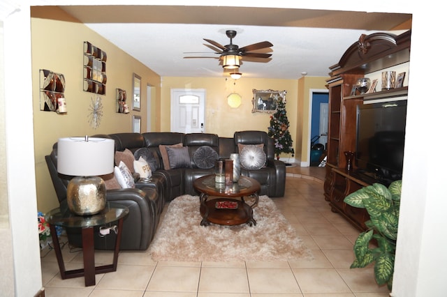 tiled living room with ceiling fan