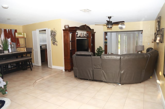 living room with ceiling fan and light tile floors