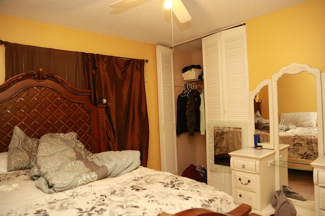 bedroom with ceiling fan, a closet, and a textured ceiling