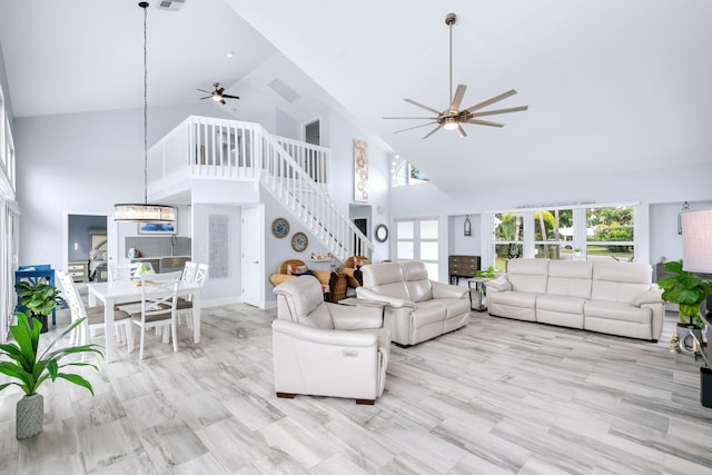 living room featuring high vaulted ceiling and ceiling fan