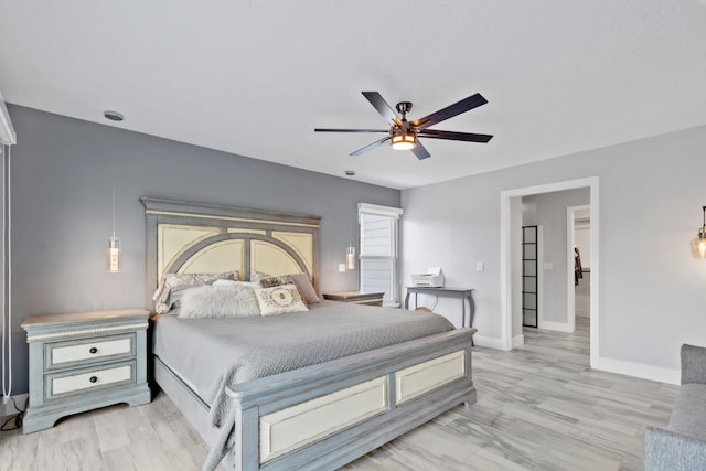 bedroom with light hardwood / wood-style floors and ceiling fan