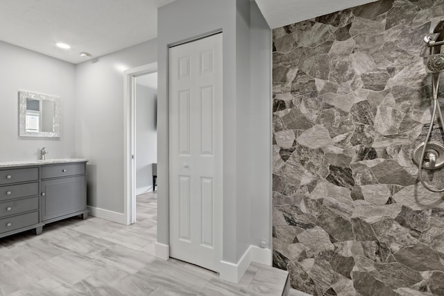 bathroom with vanity, a textured ceiling, and walk in shower