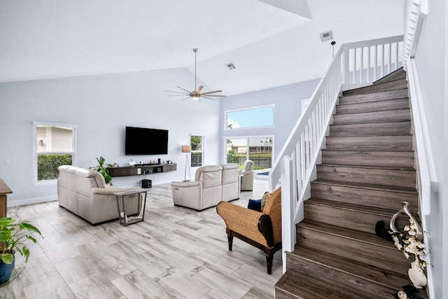 living room with high vaulted ceiling, a healthy amount of sunlight, and ceiling fan