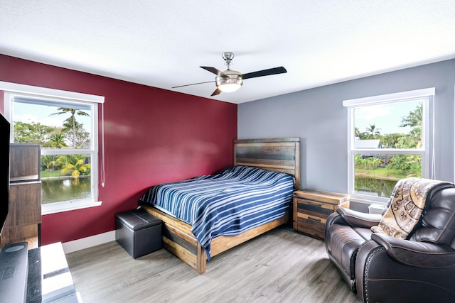 bedroom with ceiling fan and hardwood / wood-style floors