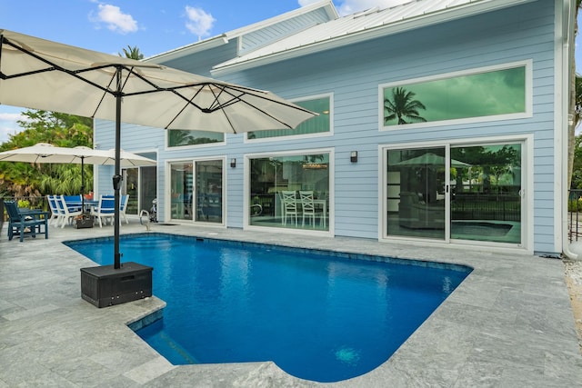 9029 SE Breeze Way, Hobe Sound, FL 33455 - outdoor pool featuring a patio and outdoor dining area