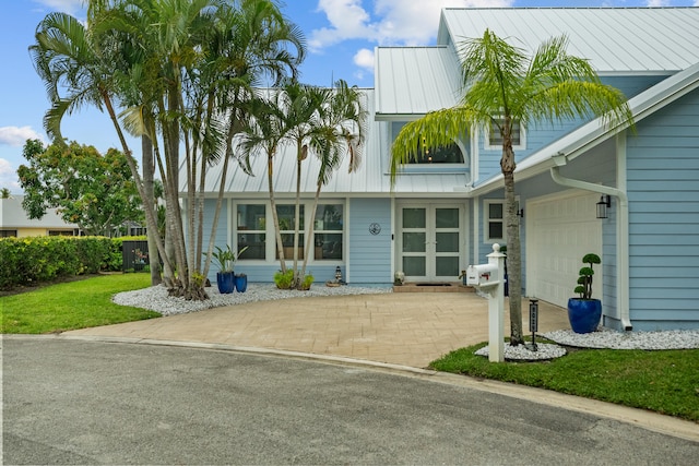 view of front of house featuring a front yard and a garage