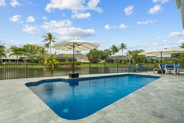 view of swimming pool featuring a patio area and a water view