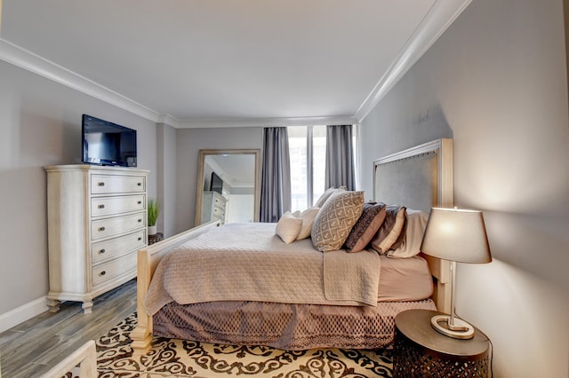 bedroom featuring crown molding and hardwood / wood-style flooring