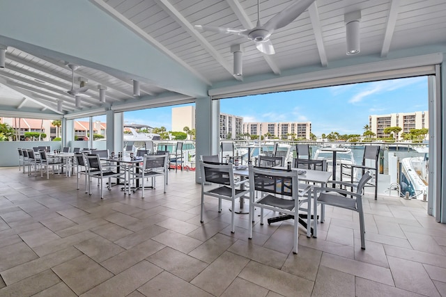 view of patio with ceiling fan and a community pool