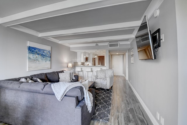 living room featuring beamed ceiling and wood-type flooring