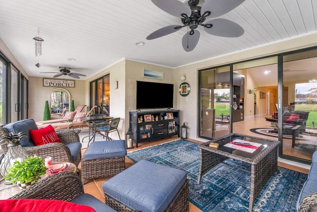 living room with ceiling fan and ornamental molding