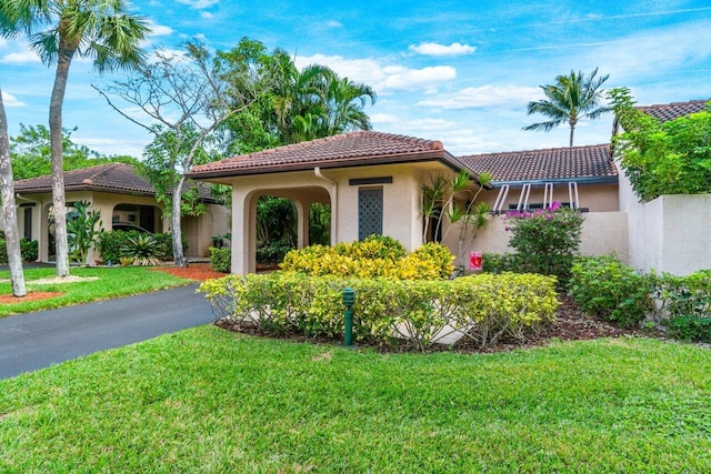 mediterranean / spanish house with a front lawn