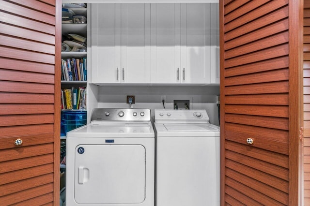 clothes washing area with washer hookup, hookup for an electric dryer, cabinets, and washer and dryer