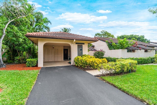 mediterranean / spanish-style house with a front yard