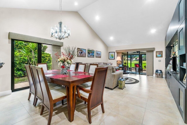 dining space featuring an inviting chandelier, high vaulted ceiling, and light tile floors