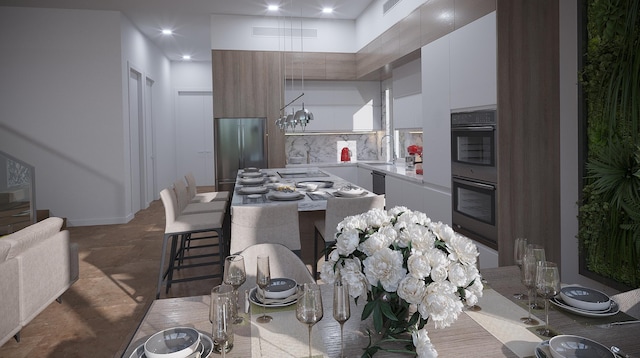 kitchen featuring appliances with stainless steel finishes, sink, tasteful backsplash, white cabinetry, and tile floors