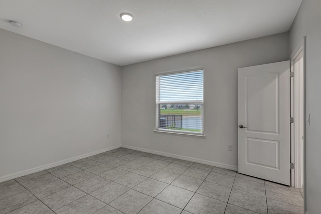 spare room with light tile flooring