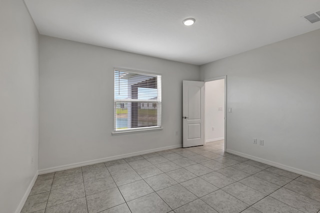 spare room with light tile floors