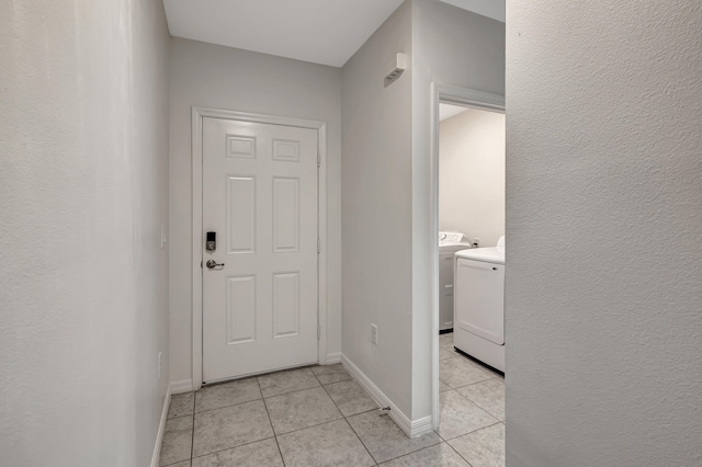 interior space featuring independent washer and dryer and light tile floors