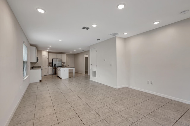 unfurnished living room with light tile flooring