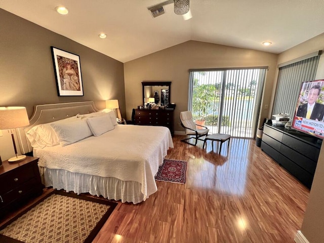 bedroom with access to outside, hardwood / wood-style flooring, and vaulted ceiling