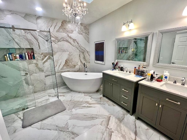 bathroom with a notable chandelier, vanity, and independent shower and bath