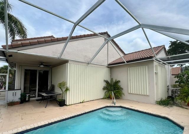 rear view of property with ceiling fan, a patio, and a lanai