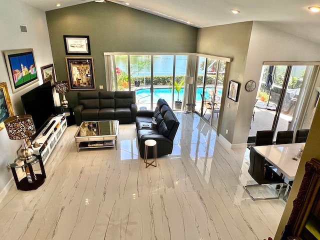 living room with high vaulted ceiling