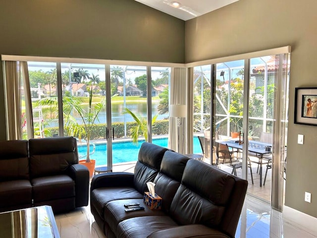 tiled living room featuring a water view