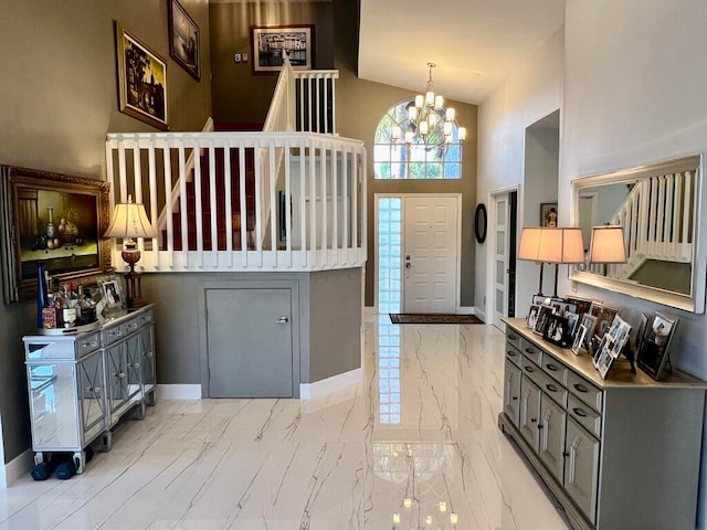 foyer entrance with a notable chandelier and high vaulted ceiling