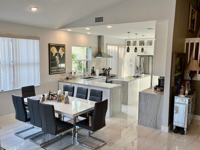 dining area with lofted ceiling and sink