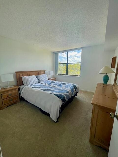 bedroom featuring carpet flooring and a textured ceiling