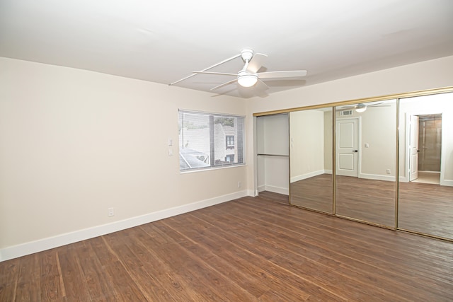 unfurnished bedroom with ceiling fan, a closet, and dark wood-type flooring