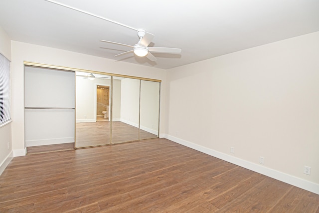 unfurnished bedroom with ceiling fan, a closet, and hardwood / wood-style flooring