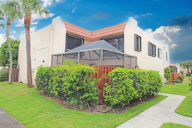 view of side of property with a yard