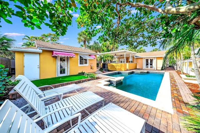 view of pool featuring a hot tub and a patio