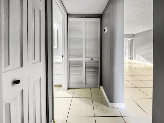 hall with light tile flooring