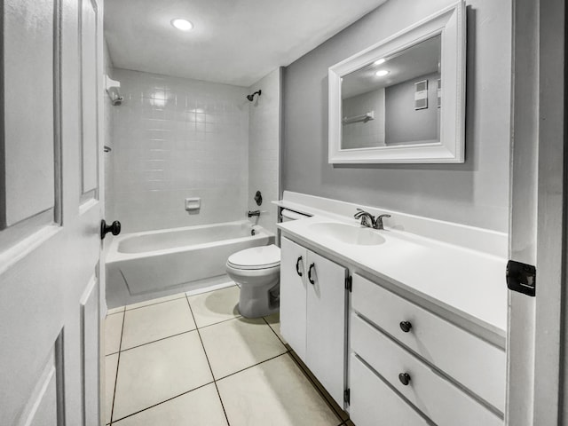 full bathroom featuring tiled shower / bath, toilet, tile flooring, and vanity