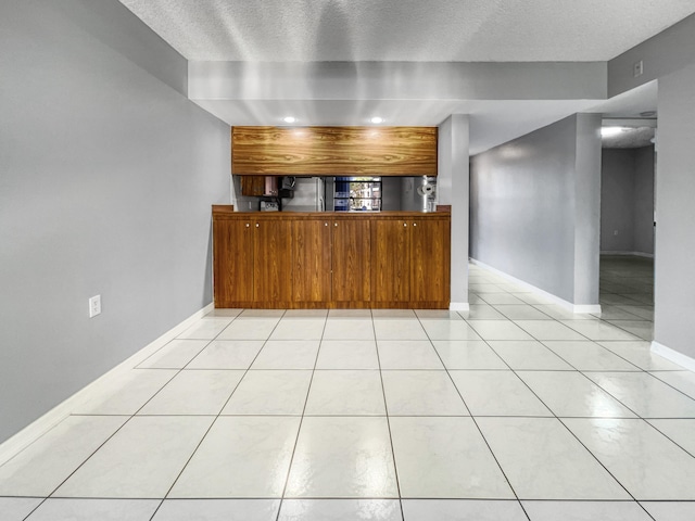 kitchen with light tile floors and a textured ceiling