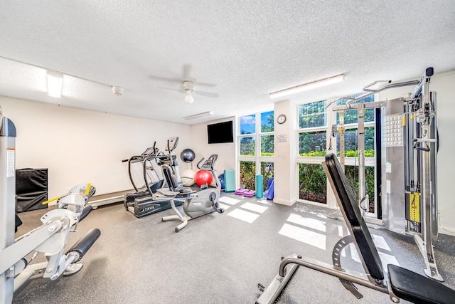 workout area featuring a textured ceiling and ceiling fan