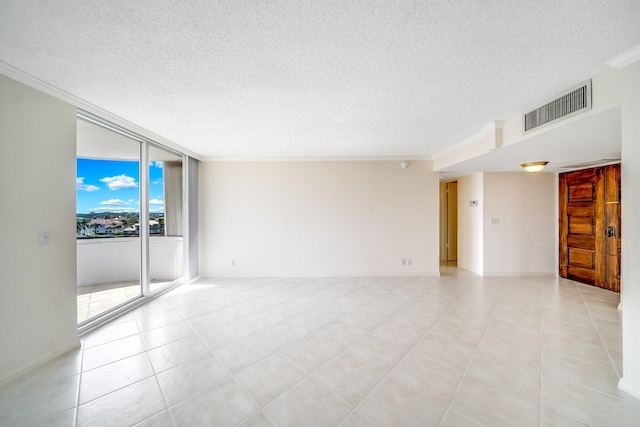 empty room featuring ornamental molding and light tile patterned floors