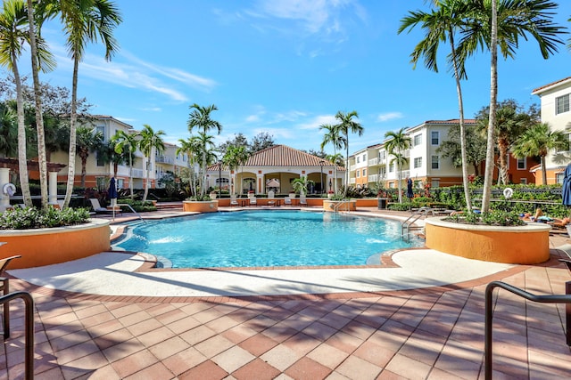 view of swimming pool with a patio area and pool water feature