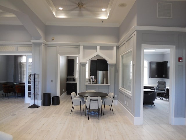 unfurnished living room featuring ceiling fan, ornamental molding, and light hardwood / wood-style flooring